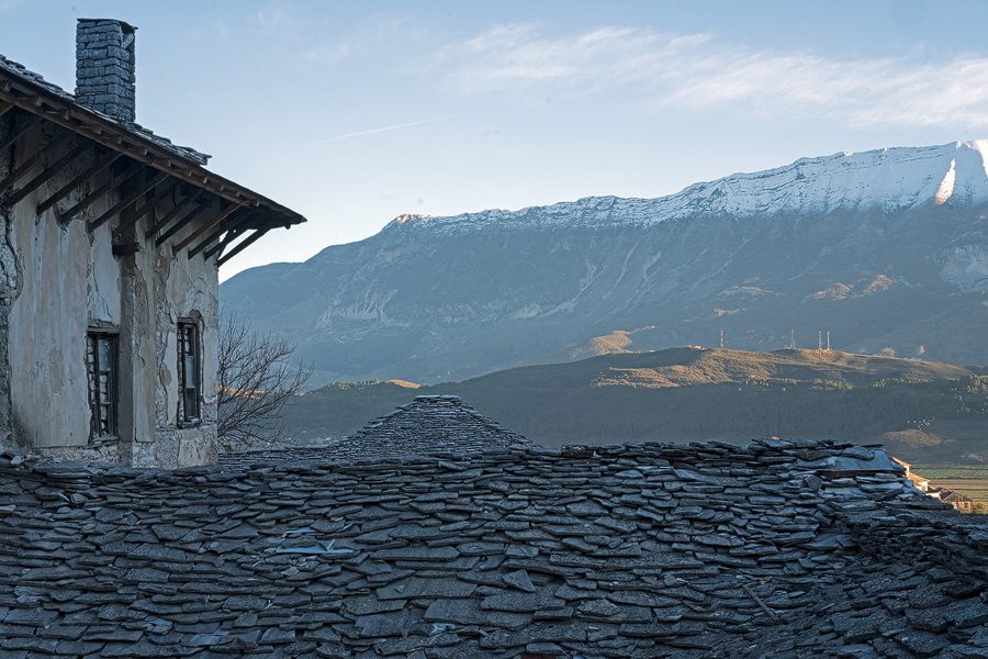 The steep, stone-tiled roofs of Gjirokaster.