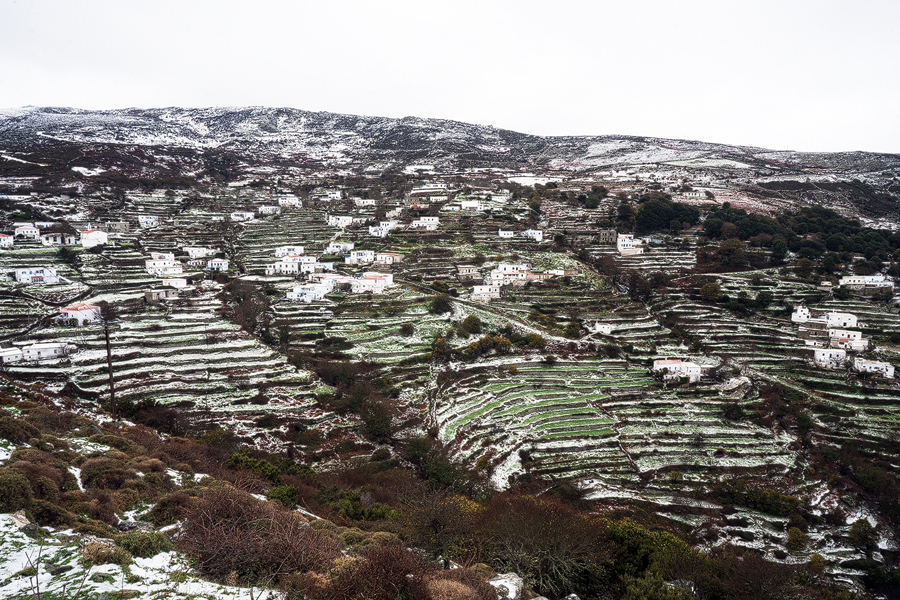 Terraces around a mountain village, after a light snowfall.